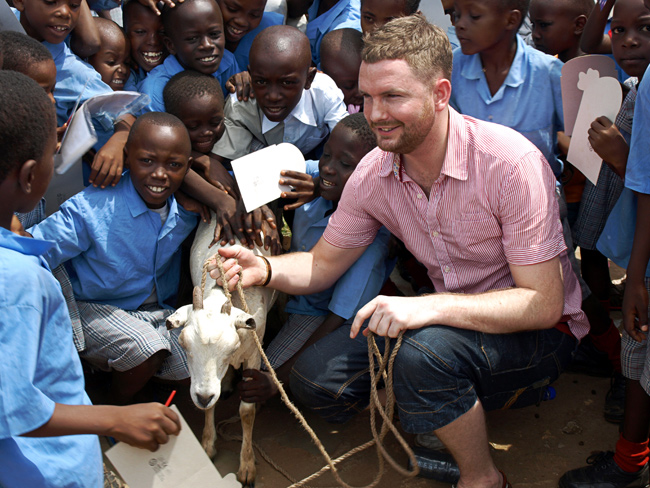 Volunteer Guy with the goat he bought Destiny Garden School.