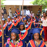 Graduating kindergarten pupils make their way to the Hall